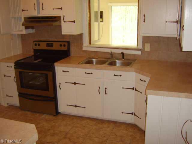 750 Lacock Avenue Rural Hall, NC 27045 - Photo 4 of 6 Other. Kitchen with new stainless appliances, countertop and tile backsplash.