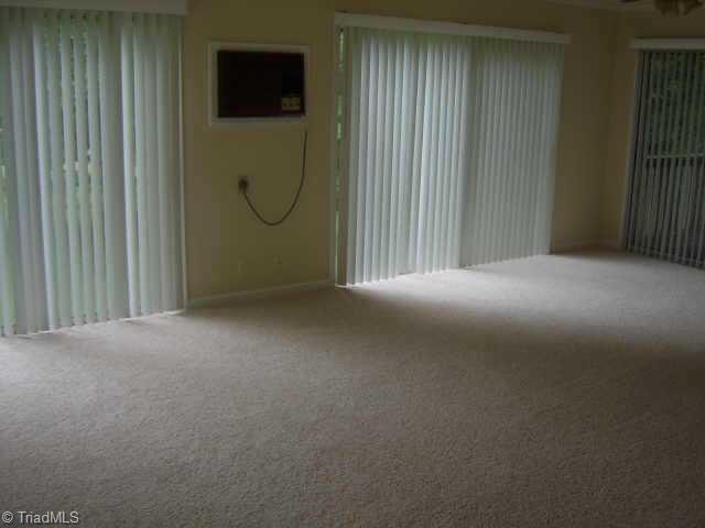 750 Lacock Avenue Rural Hall, NC 27045 - Photo 6 of 6 Other. Interior view of sunroom with vertical blinds.