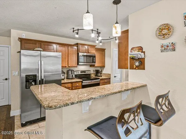 a kitchen with granite countertop a stove a sink and a granite counter top