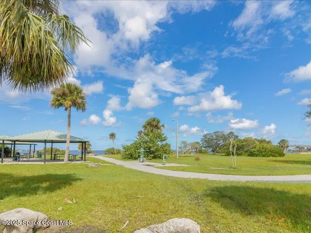 a front view of a house with a big yard