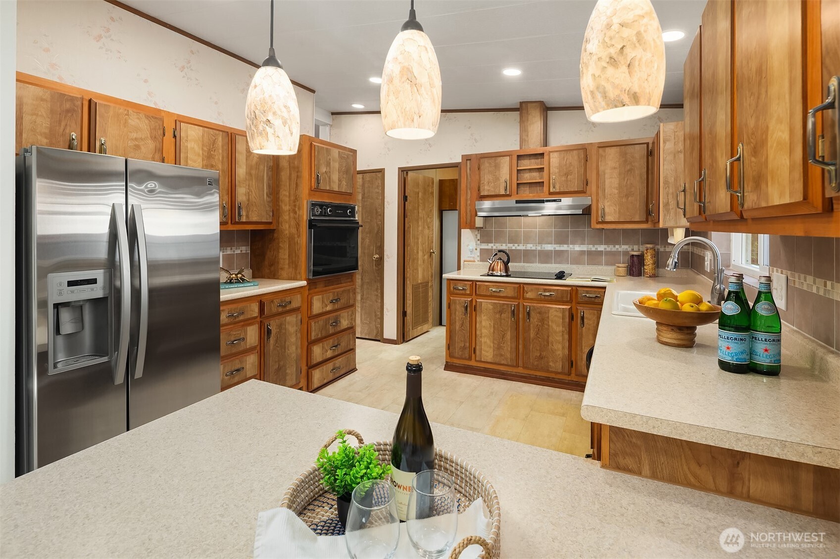 23632 9th Place West Bothell, WA 98021 - Photo 11 of 39 a kitchen with stainless steel appliances granite countertop a sink a refrigerator and a stove
