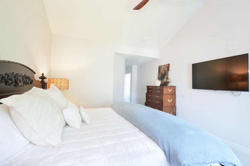17 Stratford Ridge, Unit 17 Mashpee, MA 02649 - Photo 15 of 24 a bedroom with a bed and a flat screen tv