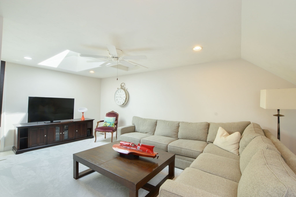 17 Stratford Ridge, Unit 17 Mashpee, MA 02649 - Photo 24 of 24 a living room with furniture and a flat screen tv