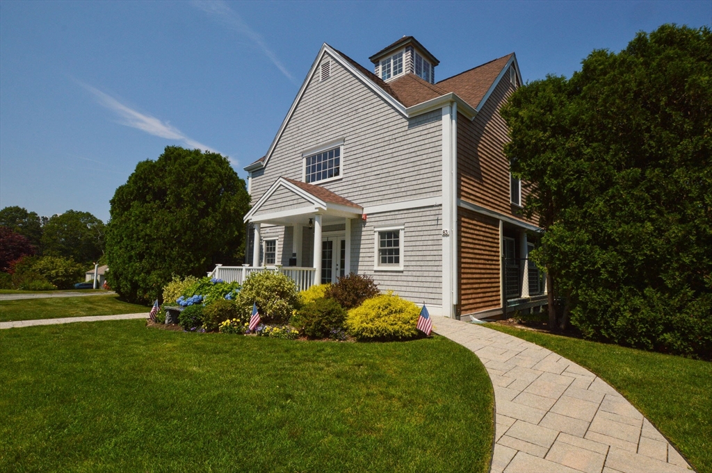 17 Stratford Ridge, Unit 17 Mashpee, MA 02649 - Photo 3 of 24 a front view of a house with garden