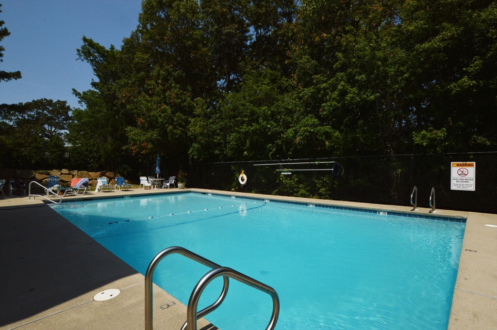 17 Stratford Ridge, Unit 17 Mashpee, MA 02649 - Photo 4 of 24 a view of swimming pool with outdoor seating and yard