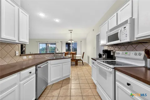 a kitchen with stainless steel appliances granite countertop a sink and cabinets