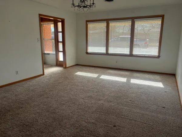 an empty room with a empty space and windows