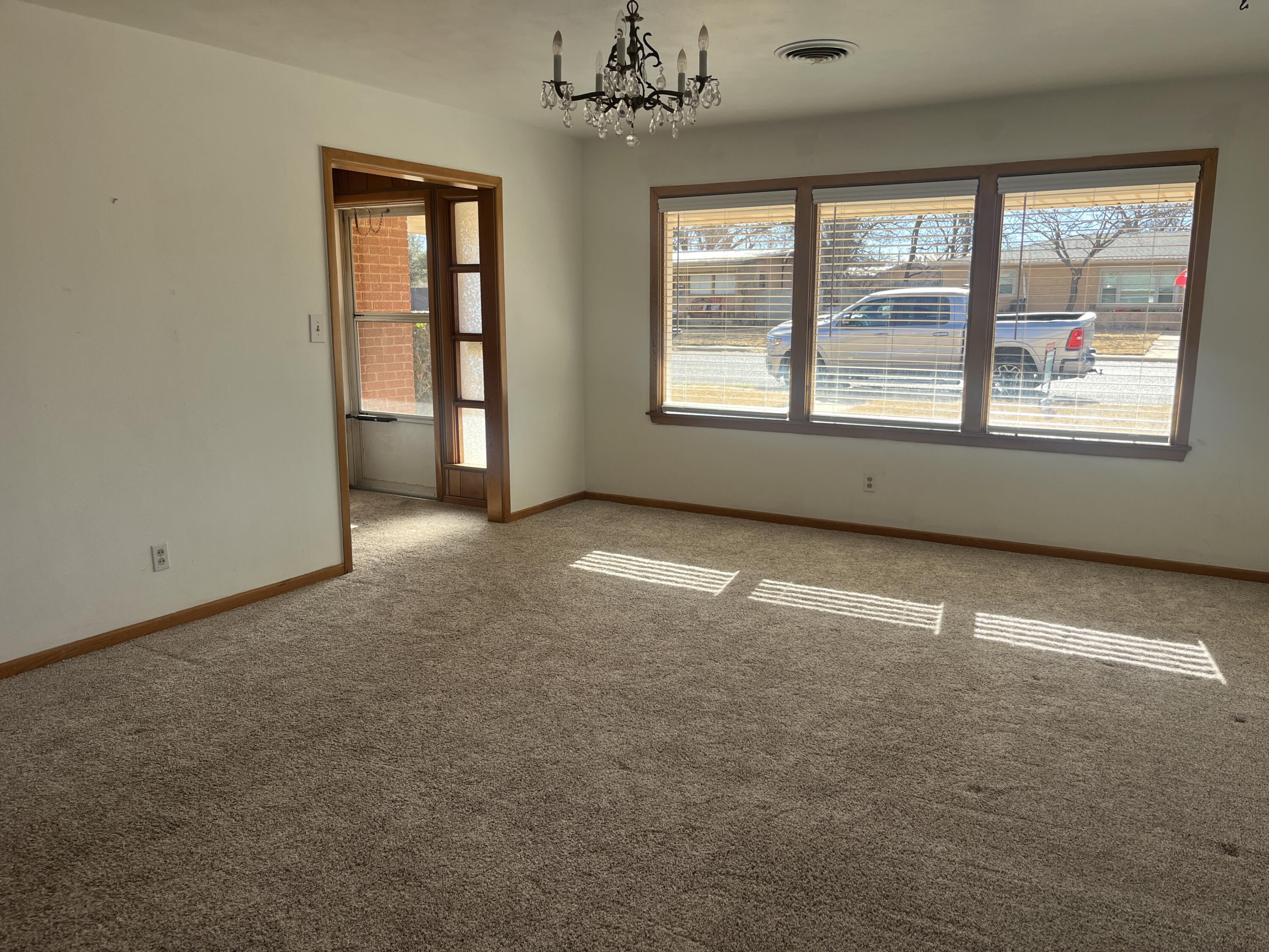 404 North 21st Street Lamesa, TX 79331 - Photo 29 of 29 an empty room with a windows and chandelier