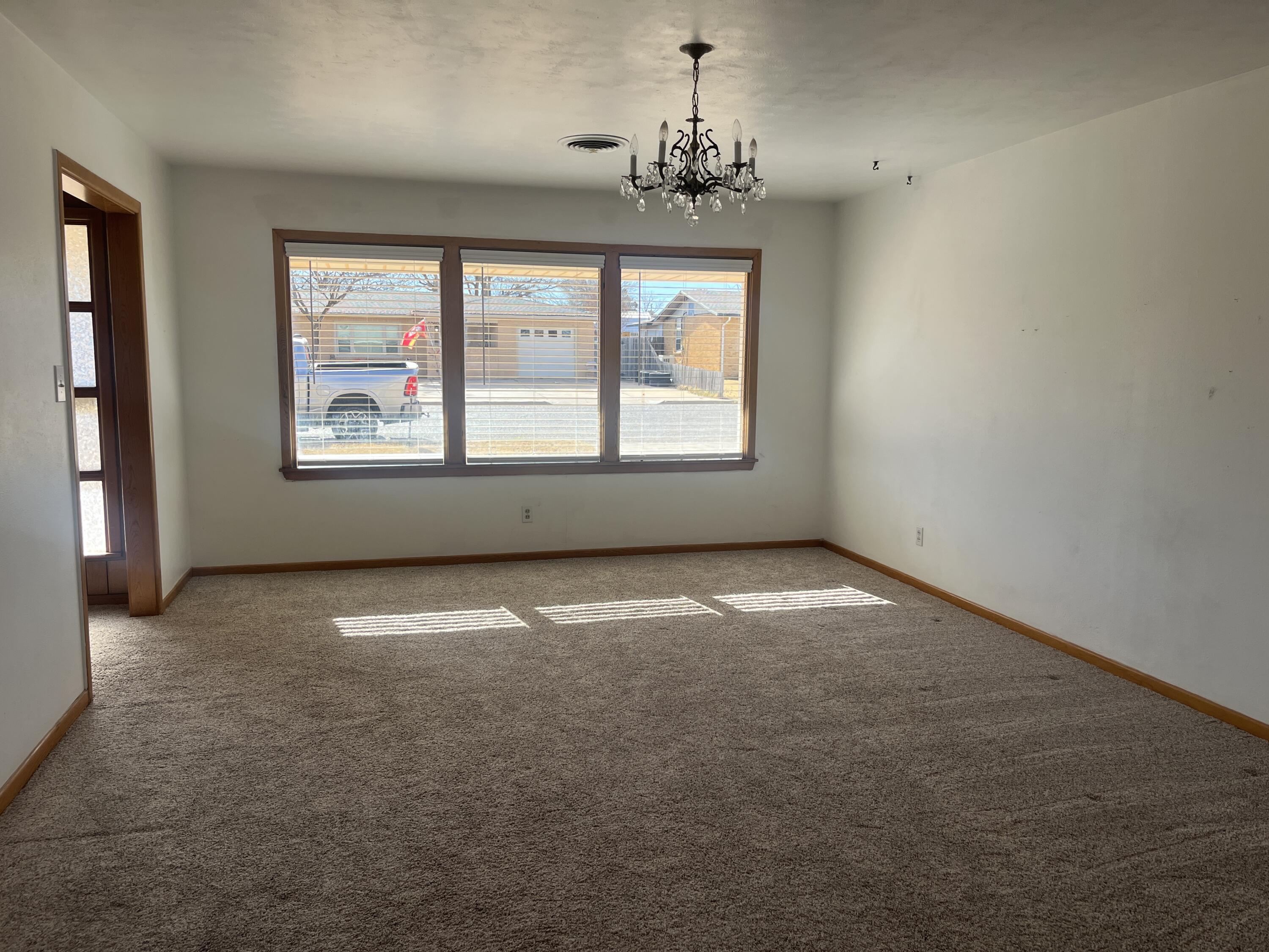 404 North 21st Street Lamesa, TX 79331 - Photo 3 of 29 an empty room with a empty space and windows