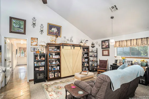 a bedroom with furniture and a book shelf
