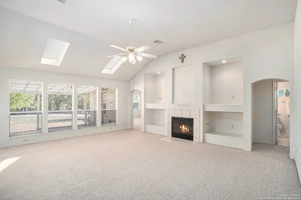 a view of a livingroom with an empty space and a fireplace