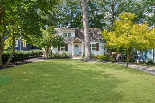 a front view of a house with a garden