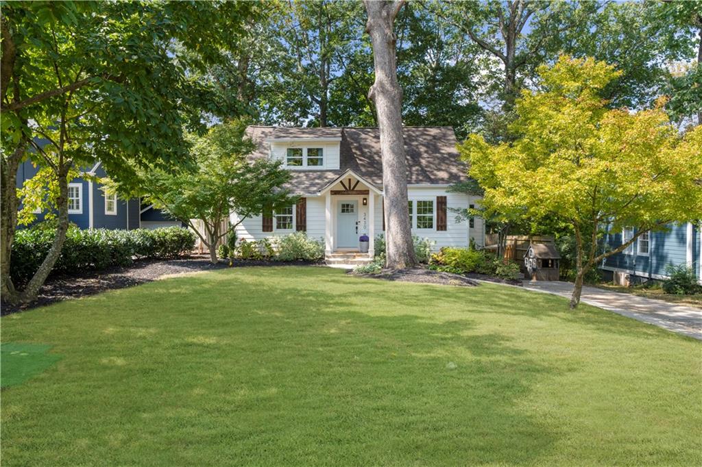 a front view of a house with a garden