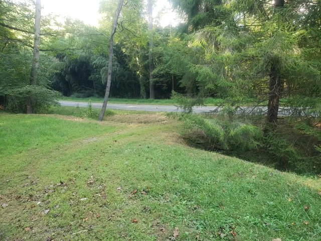 a bedroom with a bed and a couch with window