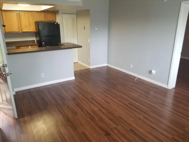 a kitchen with stainless steel appliances wooden floors and view