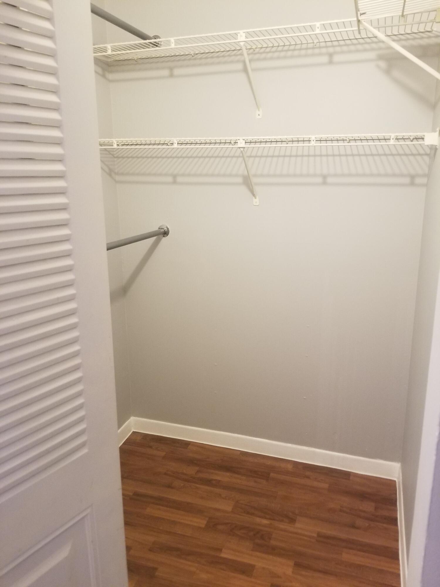 718 Executive Center Drive, Unit 19 West Palm Beach, FL 33401 - Photo 7 of 20 a view of a room with racks on the wall