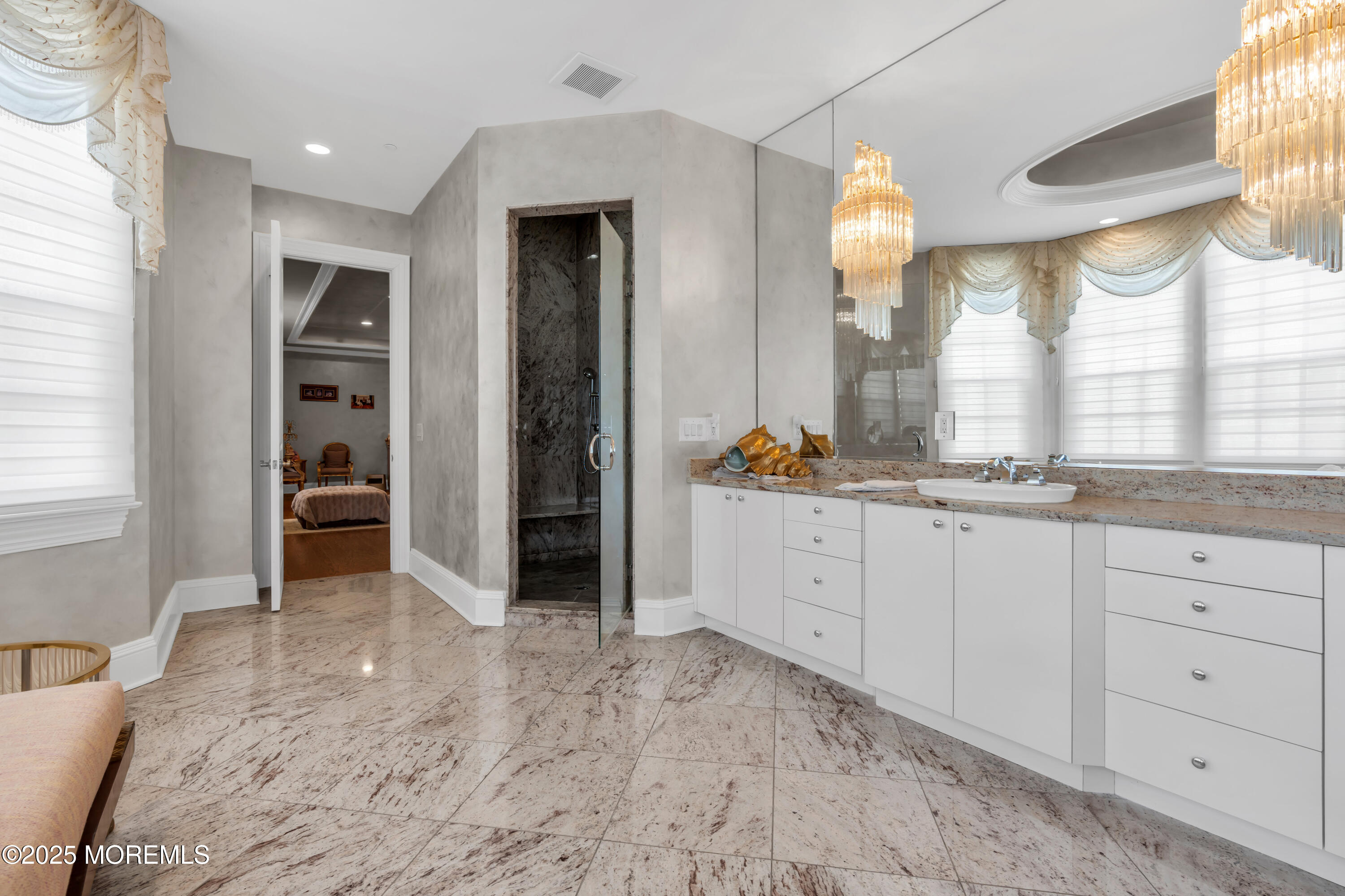 1041 Oval Road Manasquan, NJ 08736 - Photo 23 of 30 a spacious bathroom with a double vanity sink and a mirror