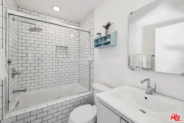 a bathroom with a shower and a sink