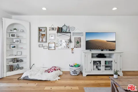 a living room with fireplace furniture and a flat screen tv