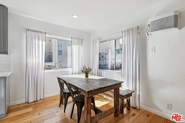 a view of a dining room with furniture and wooden floor