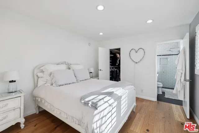 a bedroom with a bed and a large mirror