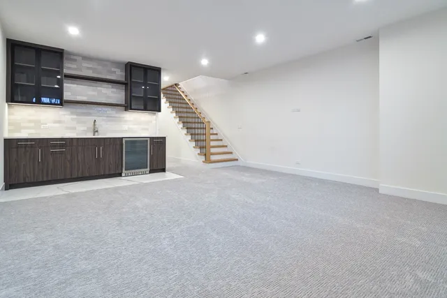 a kitchen with granite countertop a sink and cabinets