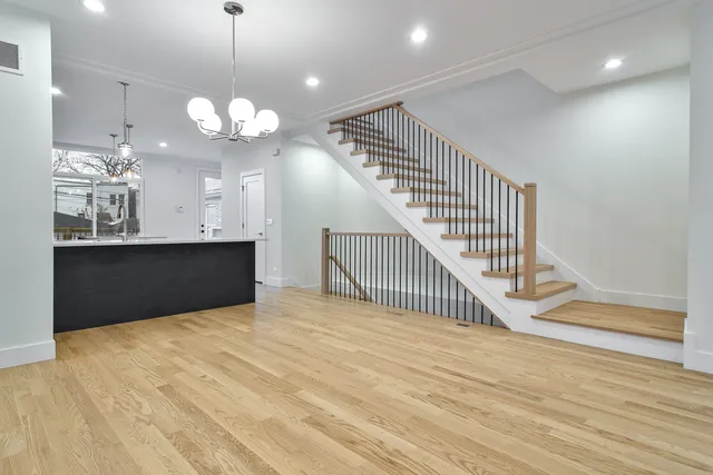 a view of a room with wooden floor and staircase