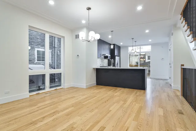 a view of a kitchen with a sink and a refrigerator
