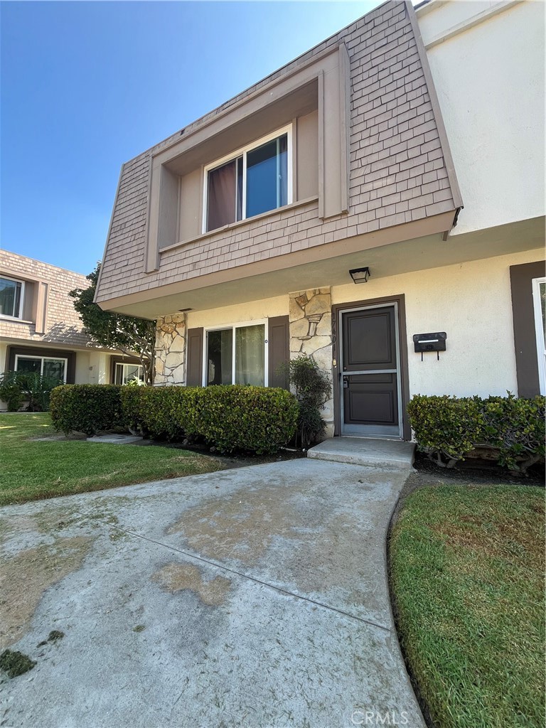 17401 Appalachian Street Fountain Valley, CA 92708 - Photo 1 of 23 a front view of a house with a garden and yard