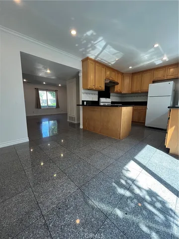 a view of a living room with kitchen