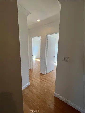 a view of a hallway with wooden floor