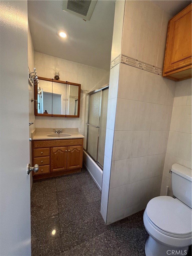 17401 Appalachian Street Fountain Valley, CA 92708 - Photo 20 of 23 a bathroom with a toilet a sink and mirror
