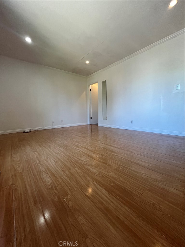 17401 Appalachian Street Fountain Valley, CA 92708 - Photo 21 of 23 an empty room with wooden floor and windows