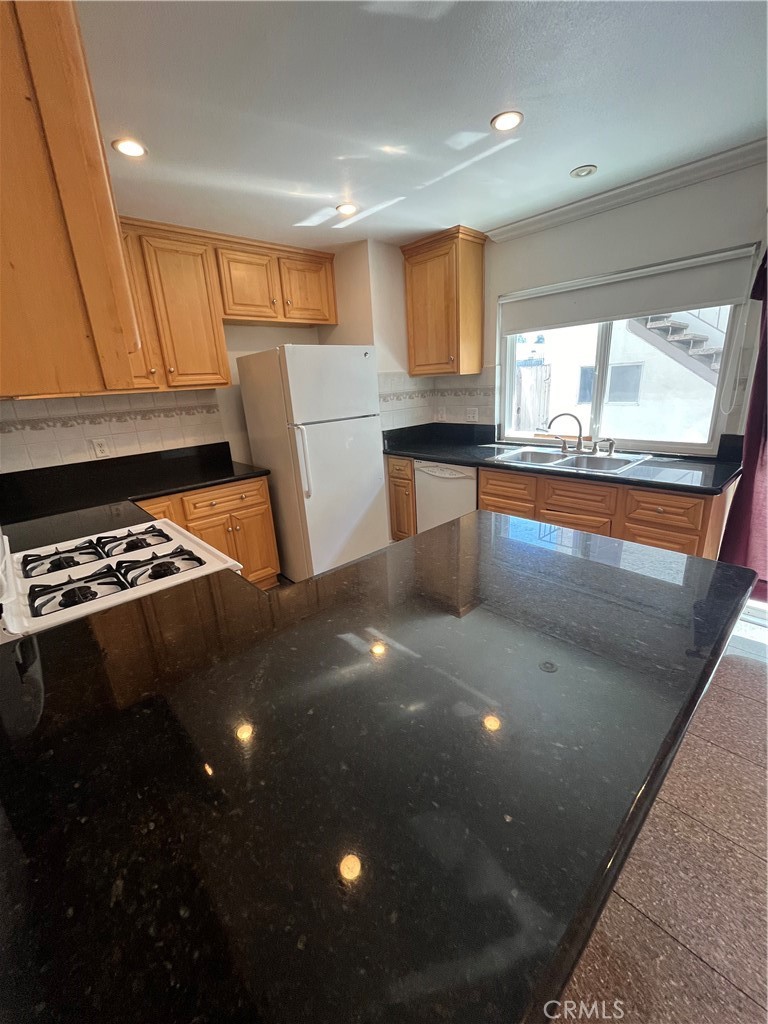 17401 Appalachian Street Fountain Valley, CA 92708 - Photo 9 of 23 a kitchen with stainless steel appliances a sink stove and cabinets