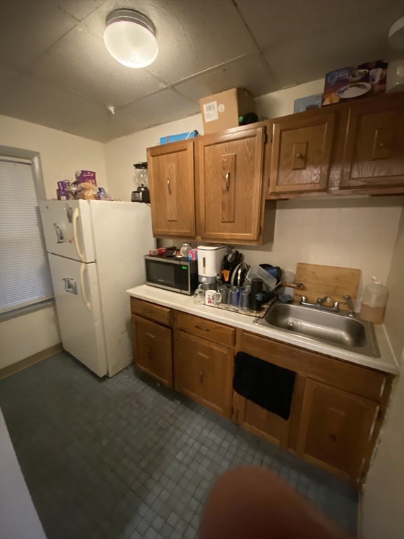 9 Fifth Avenue Worcester, MA 01607 - Photo 33 of 41 a kitchen with refrigerator and cabinets