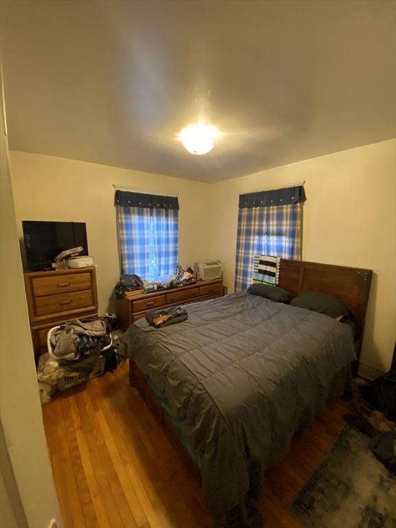 9 Fifth Avenue Worcester, MA 01607 - Photo 6 of 41 a bed sitting in a bedroom next to a window