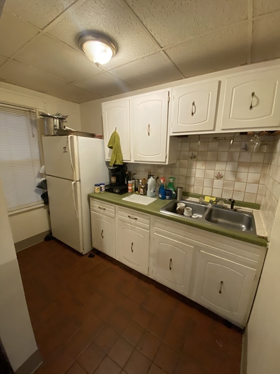 9 Fifth Avenue Worcester, MA 01607 - Photo 8 of 41 a kitchen with stainless steel appliances a refrigerator a sink and cabinets
