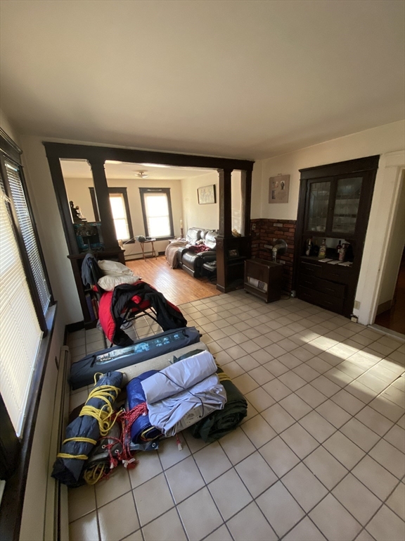 9 Fifth Avenue Worcester, MA 01607 - Photo 9 of 41 a living room with furniture a flat screen tv and a floor to ceiling window