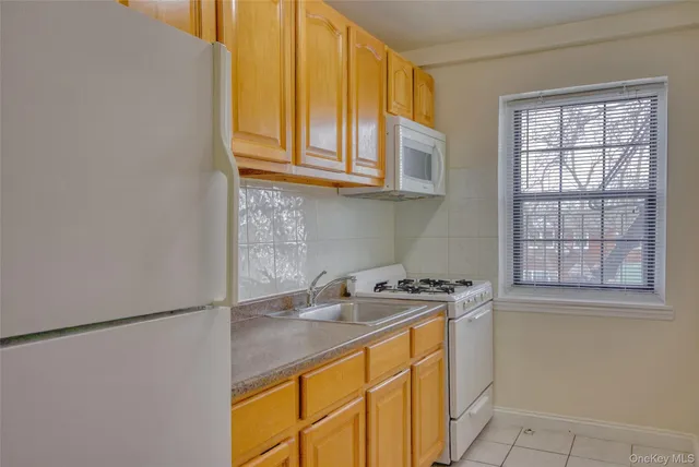 a kitchen with stainless steel appliances granite countertop a sink and a window