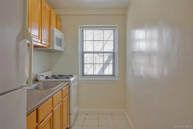a utility room with cabinets washer and dryer