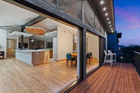 a view of a living room with a wooden deck