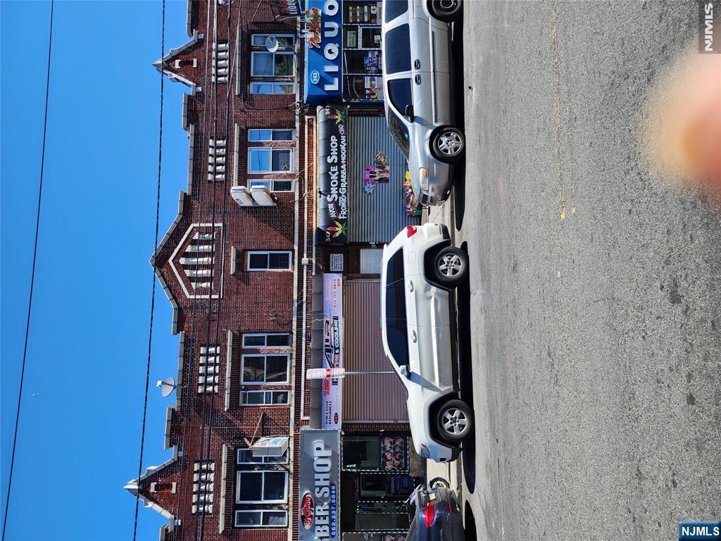 347 Avon Avenue Newark, NJ 07108 - Photo 1 of 4 a car parked in front of a big house