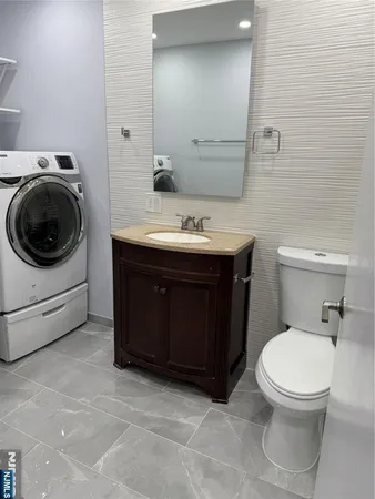 a bathroom with a sink a toilet and a mirror