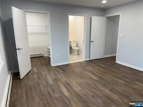 an empty room with wooden floor and a window