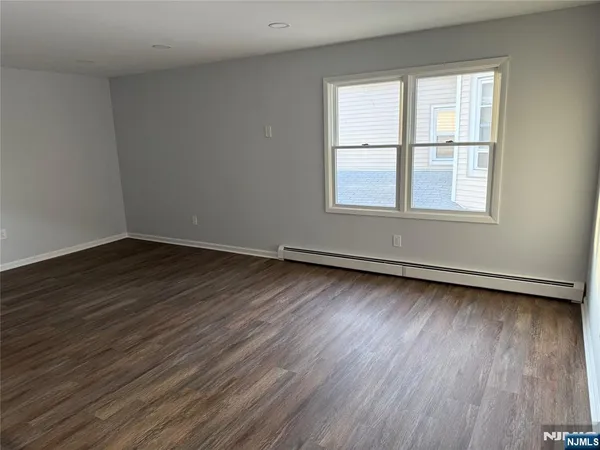 a view of a room with wooden floor and window
