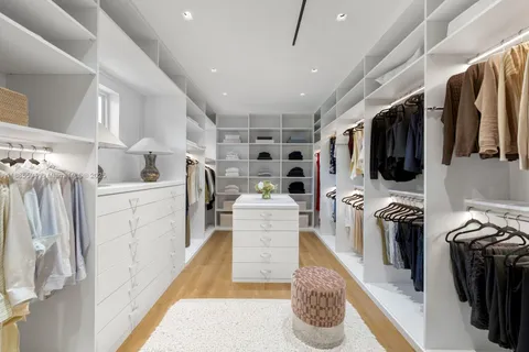 a kitchen with stainless steel appliances kitchen island granite countertop a refrigerator and a sink