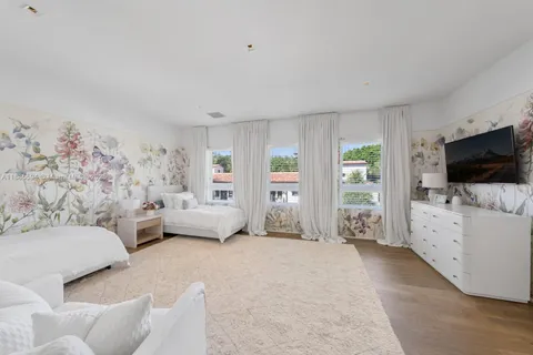 a bedroom with furniture and flat screen tv