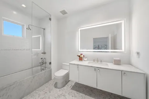 a bathroom with a sink toilet tub and shower