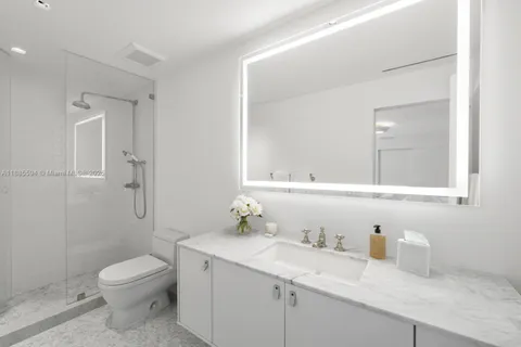 a bathroom with a granite countertop sink a toilet and a mirror