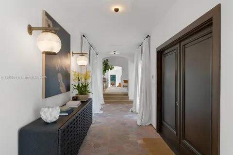 a living room with furniture and a mirror